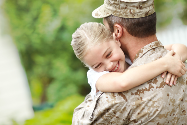 Veteran hugging child